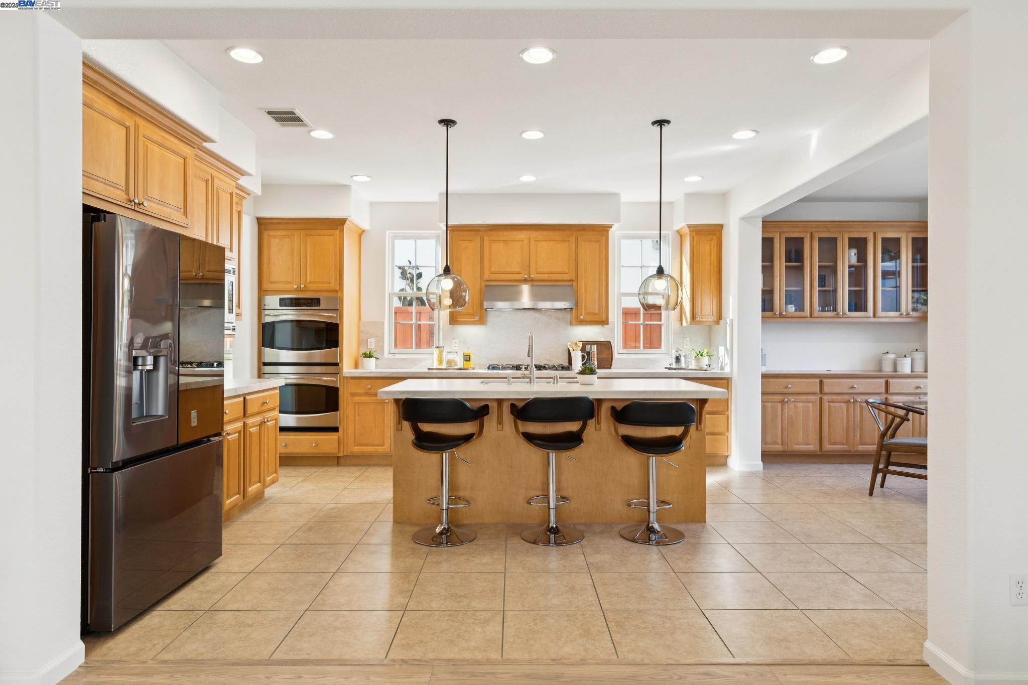 5 Cornelius Square Alameda, CA 94501 - Photo 16 of 60 a kitchen with stainless steel appliances kitchen island granite countertop a sink and cabinets