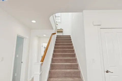 a living room with furniture a rug a clock and a window
