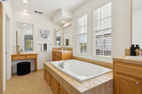 a bedroom with a bed and a lamp with the wooden floor
