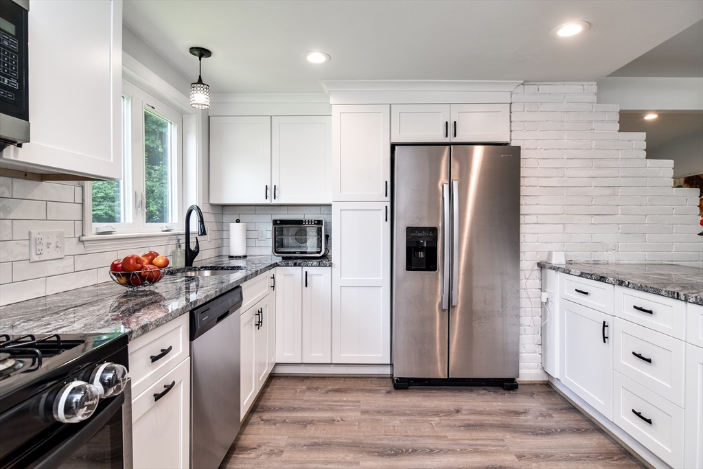 10 Ruth Drive Framingham, MA 01701 - Photo 11 of 28 a kitchen with stainless steel appliances a refrigerator stove and sink