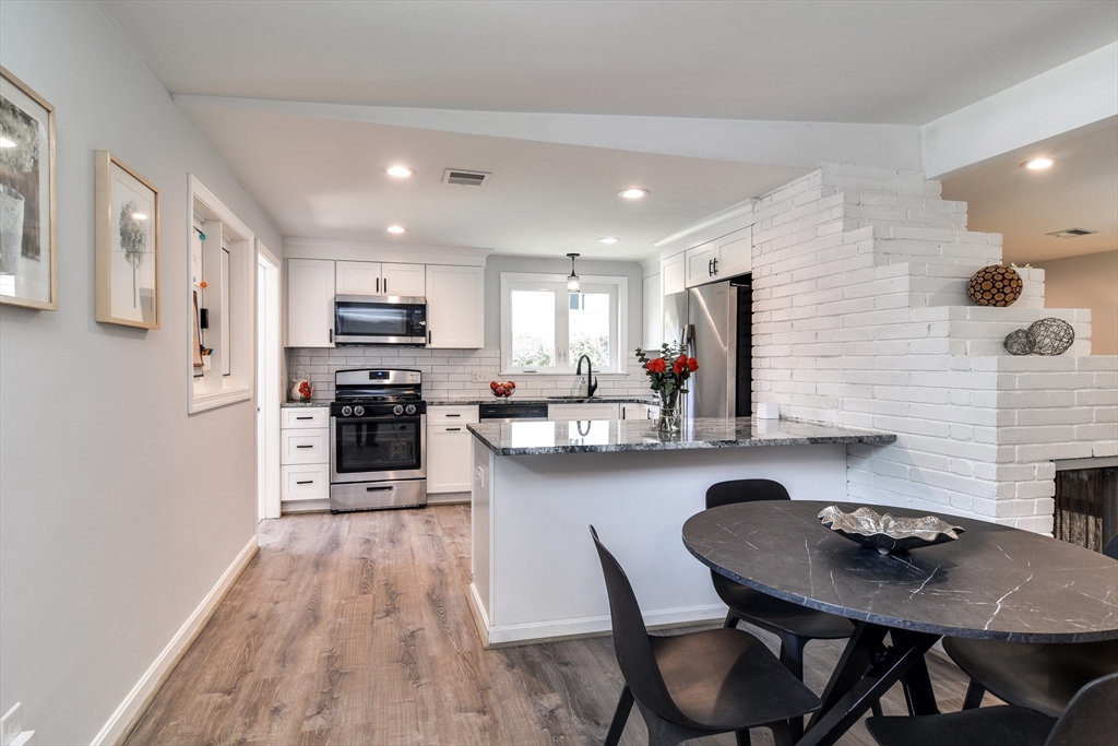 10 Ruth Drive Framingham, MA 01701 - Photo 13 of 28 a kitchen with cabinets wooden floor and stainless steel appliances