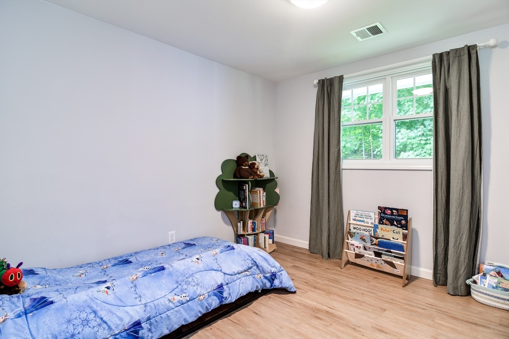 10 Ruth Drive Framingham, MA 01701 - Photo 16 of 28 a bedroom with a bed and a wooden floor