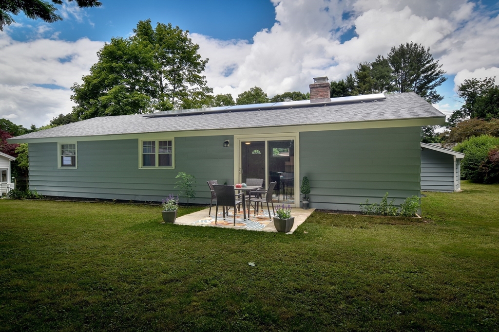 10 Ruth Drive Framingham, MA 01701 - Photo 23 of 28 a view of a backyard with table and chairs and a large tree