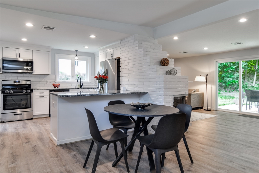 10 Ruth Drive Framingham, MA 01701 - Photo 3 of 28 a kitchen with stainless steel appliances kitchen island granite countertop a stove a sink a refrigerator dining table and chairs