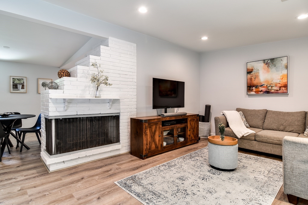 10 Ruth Drive Framingham, MA 01701 - Photo 6 of 28 a living room with furniture a flat screen tv and a fireplace