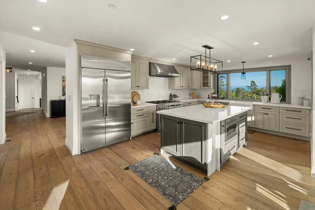 a dining room with furniture a chandelier and wooden floor