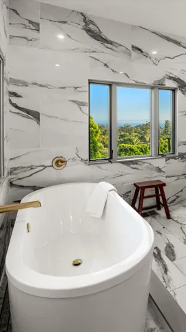 a bedroom with a large bed and a balcony