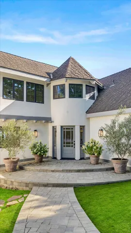 a front view of a house with a garden