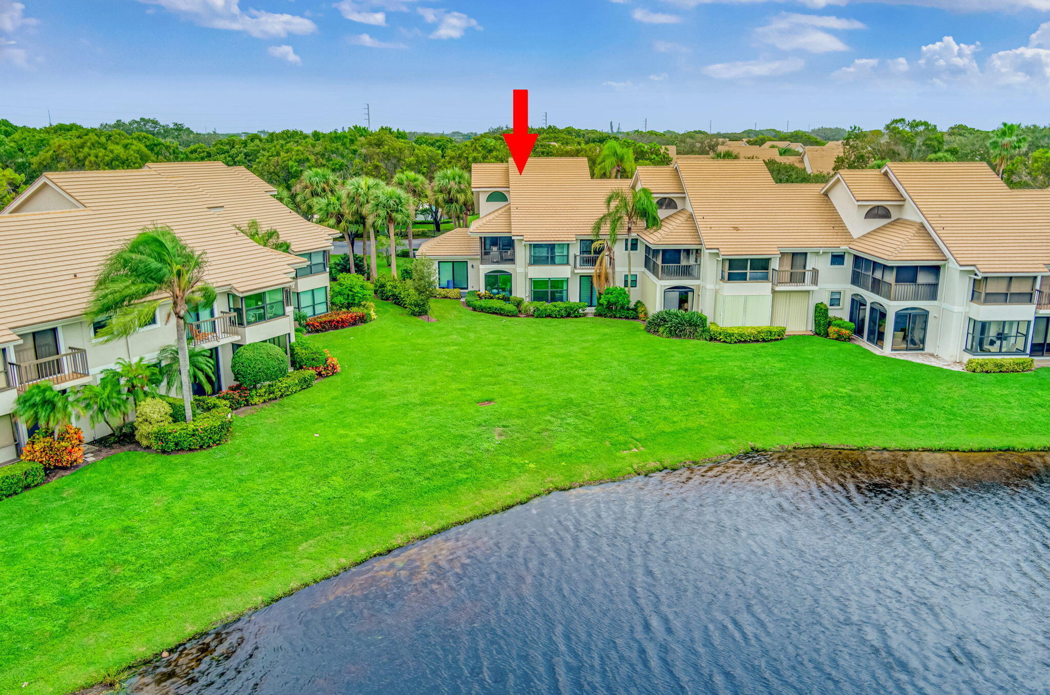 3940 Back Bay Drive, Unit 241 Jupiter, FL 33477 - Photo 1 of 19 a aerial view of a house with a yard and a large pool
