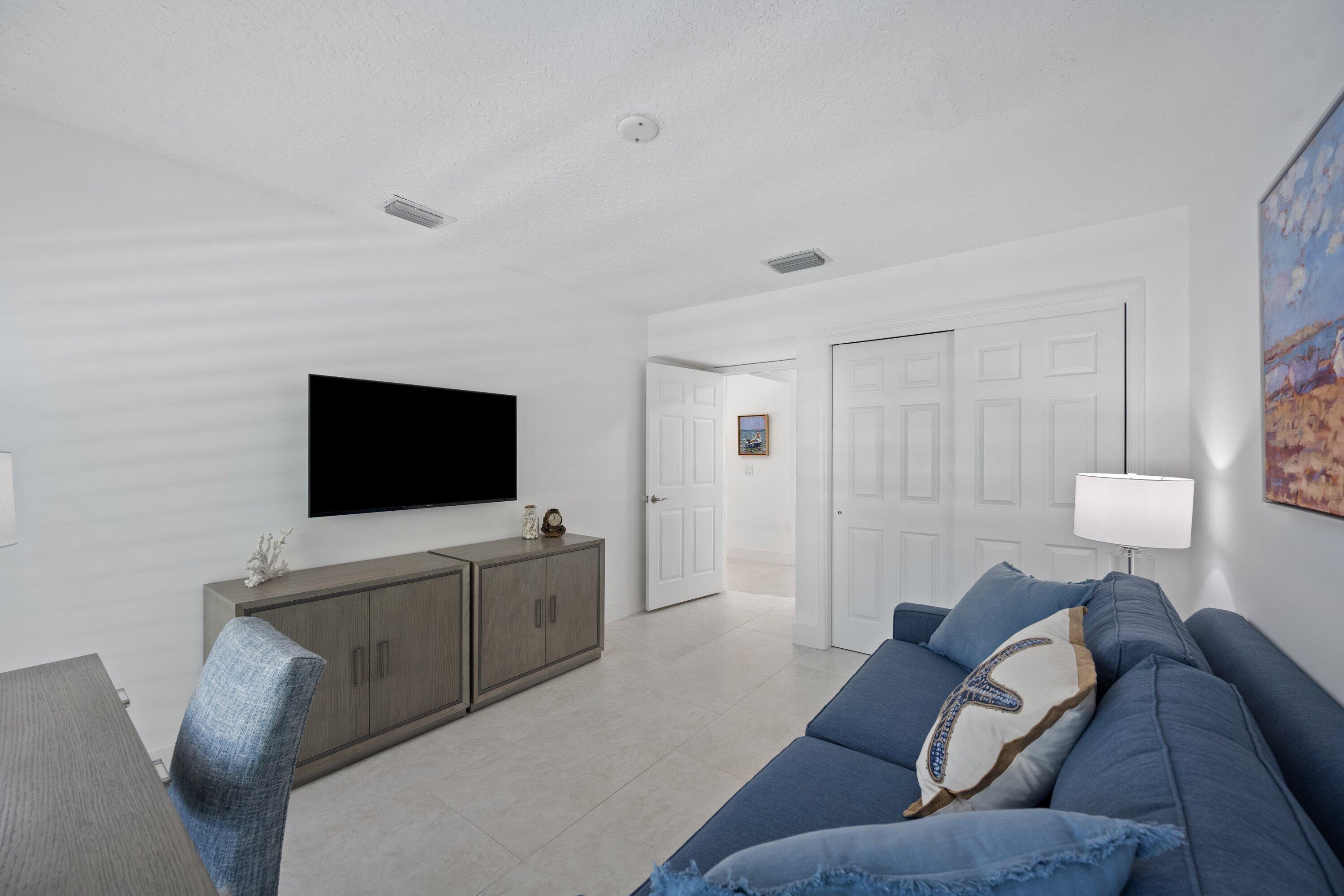 3940 Back Bay Drive, Unit 241 Jupiter, FL 33477 - Photo 11 of 19 a living room with furniture and a flat screen tv
