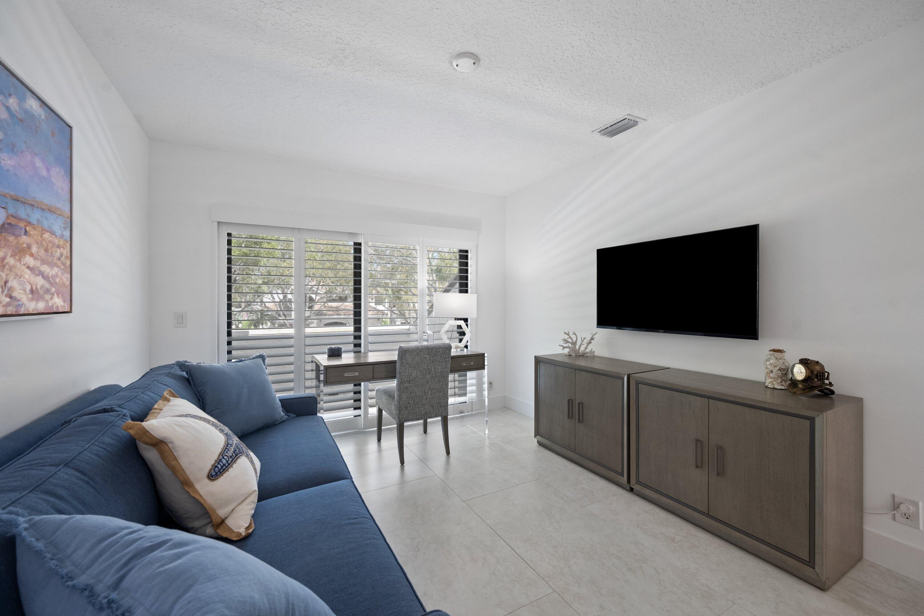 3940 Back Bay Drive, Unit 241 Jupiter, FL 33477 - Photo 12 of 19 a living room with furniture and a flat screen tv