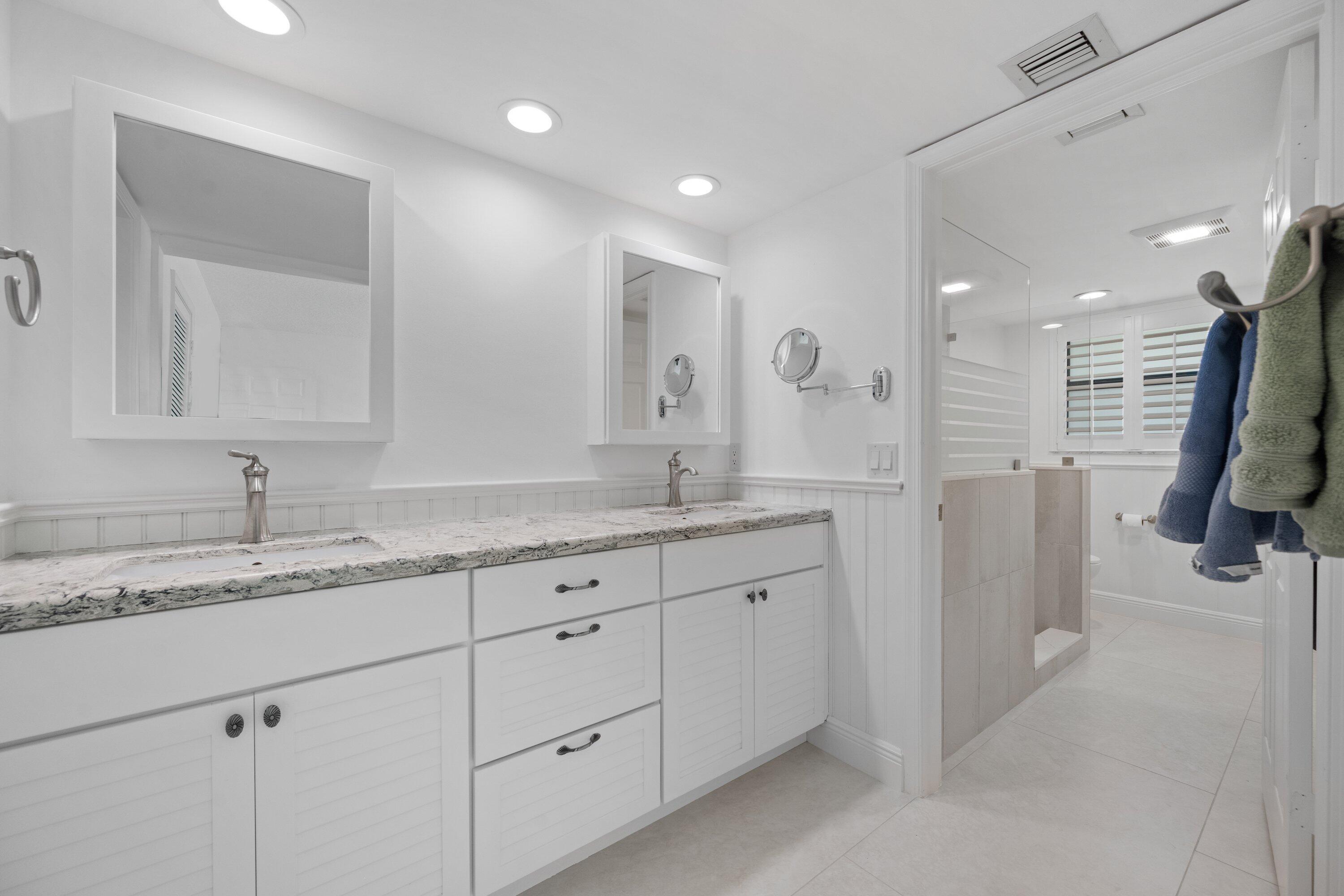 3940 Back Bay Drive, Unit 241 Jupiter, FL 33477 - Photo 14 of 19 a bathroom with a granite countertop sink mirror and double