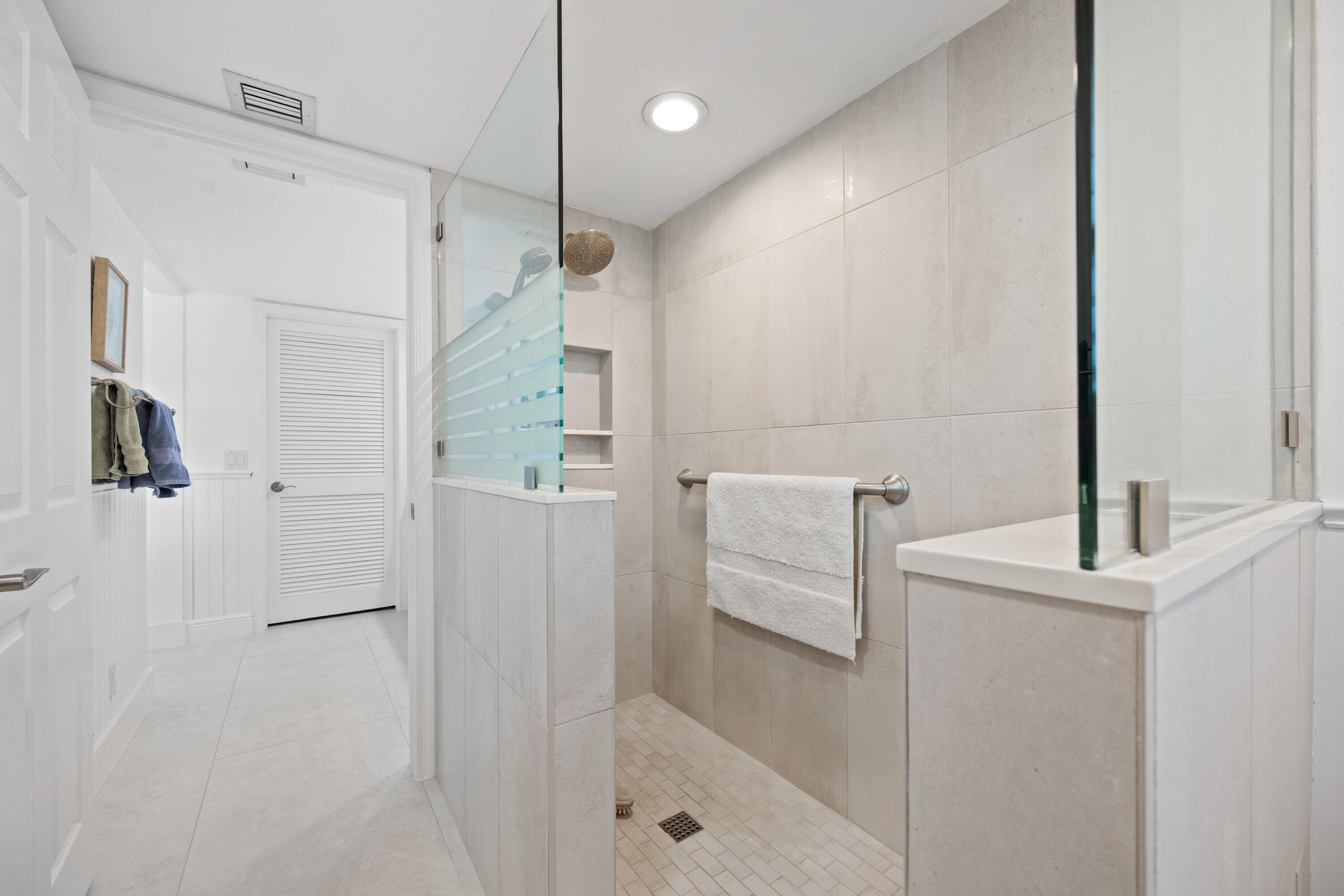 3940 Back Bay Drive, Unit 241 Jupiter, FL 33477 - Photo 15 of 19 a bathroom with a bathtub and a shower