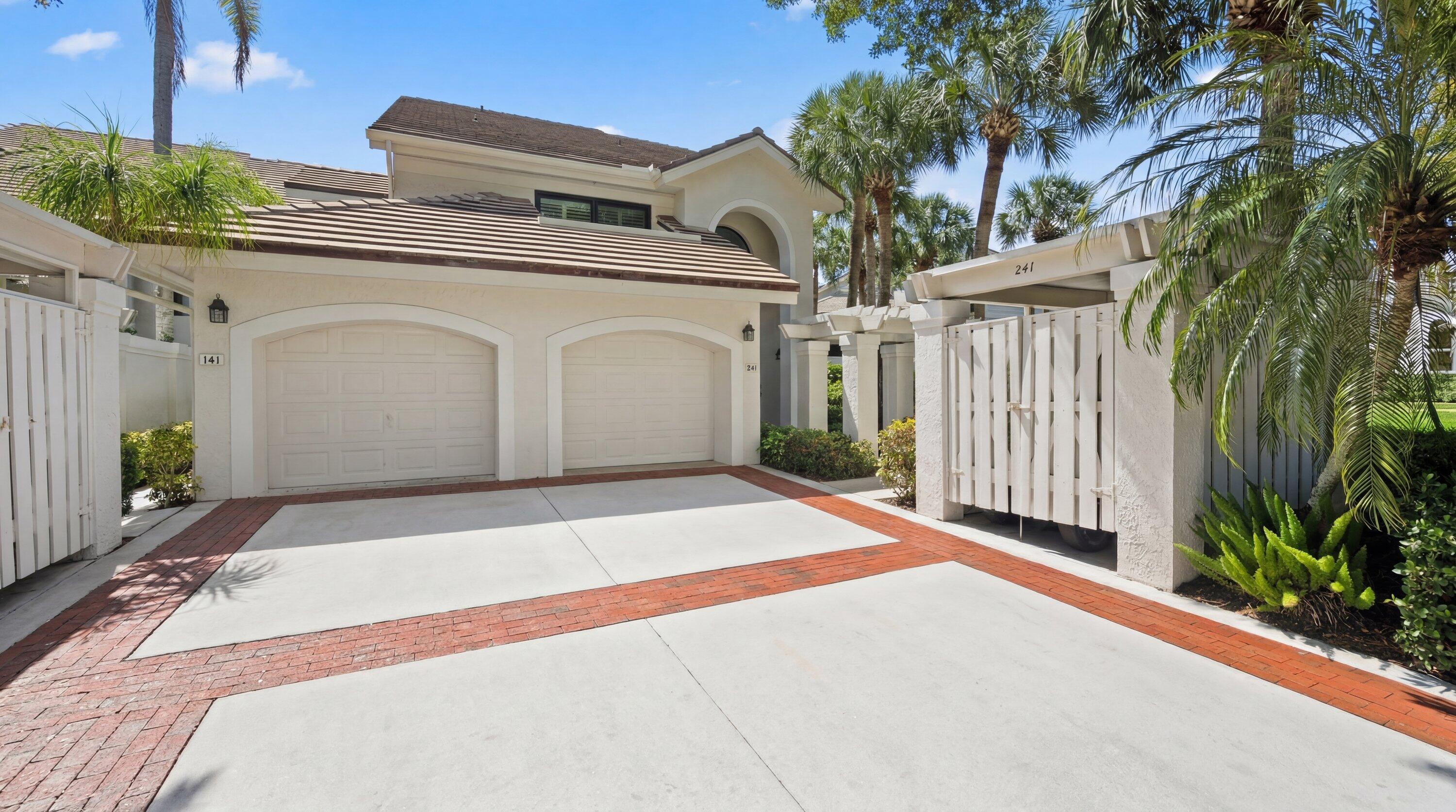 3940 Back Bay Drive, Unit 241 Jupiter, FL 33477 - Photo 2 of 19 a view of a white house with a outdoor space