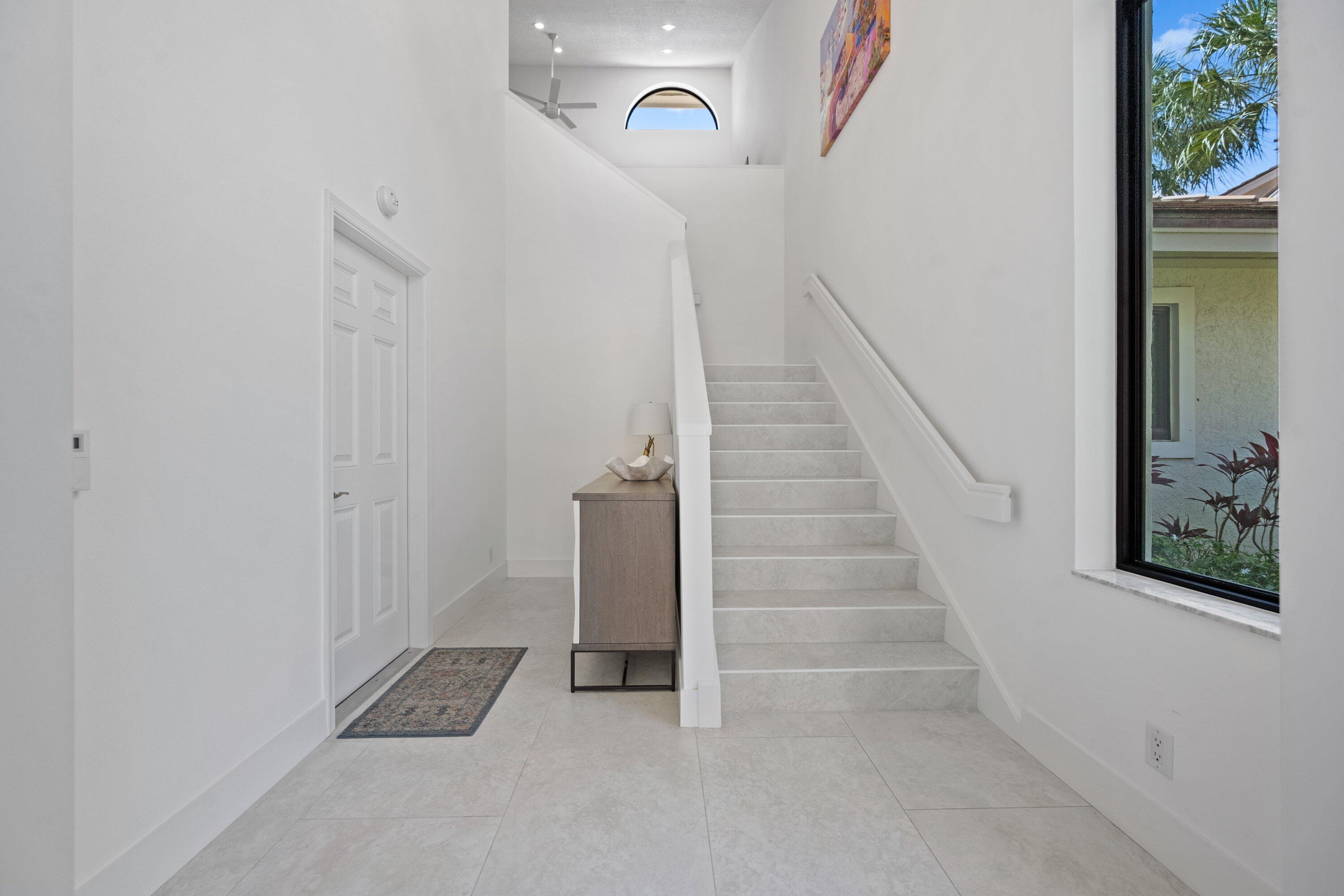 3940 Back Bay Drive, Unit 241 Jupiter, FL 33477 - Photo 3 of 19 a view of an entryway with staircase