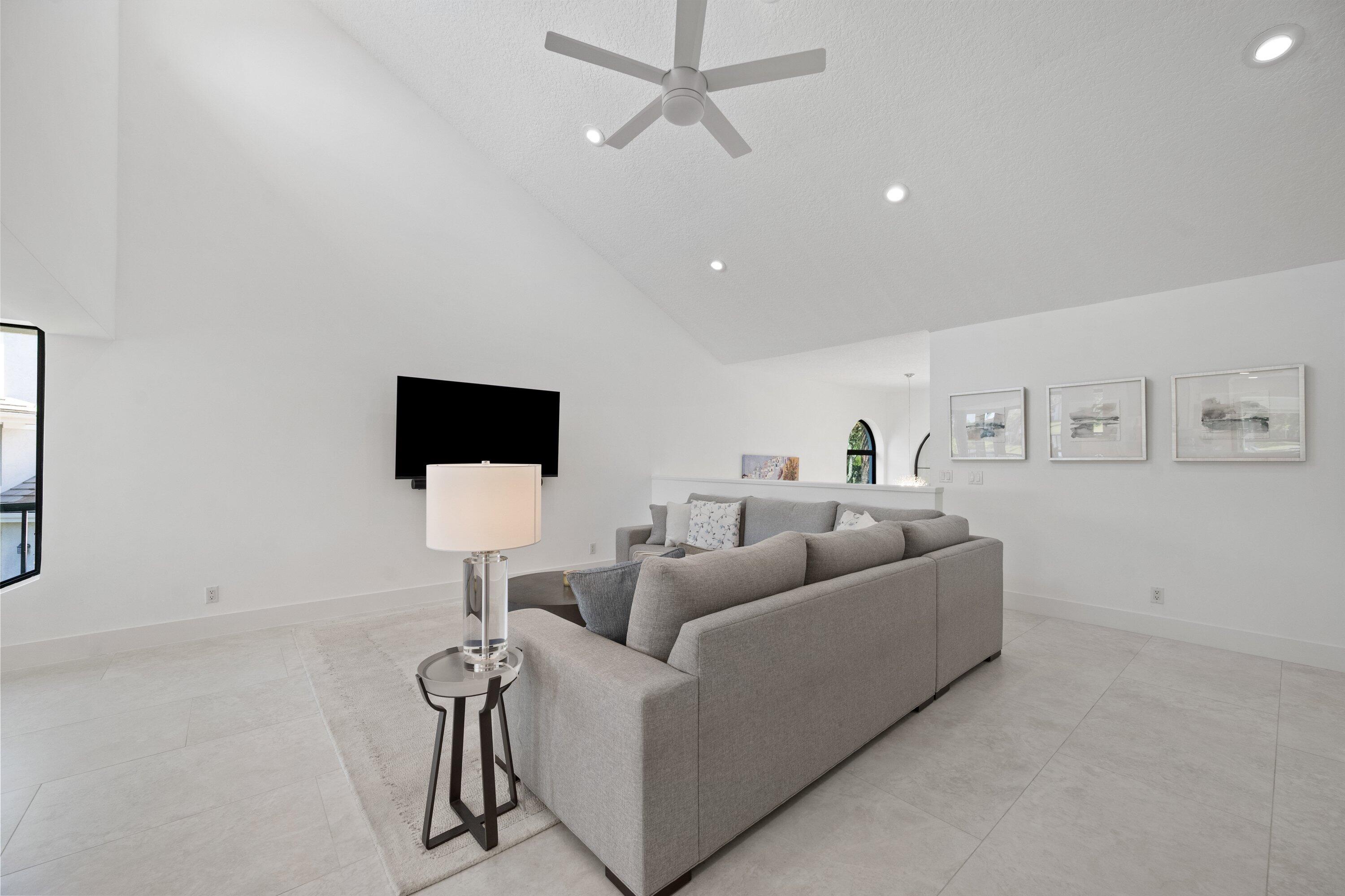3940 Back Bay Drive, Unit 241 Jupiter, FL 33477 - Photo 4 of 19 a living room with furniture and a flat screen tv