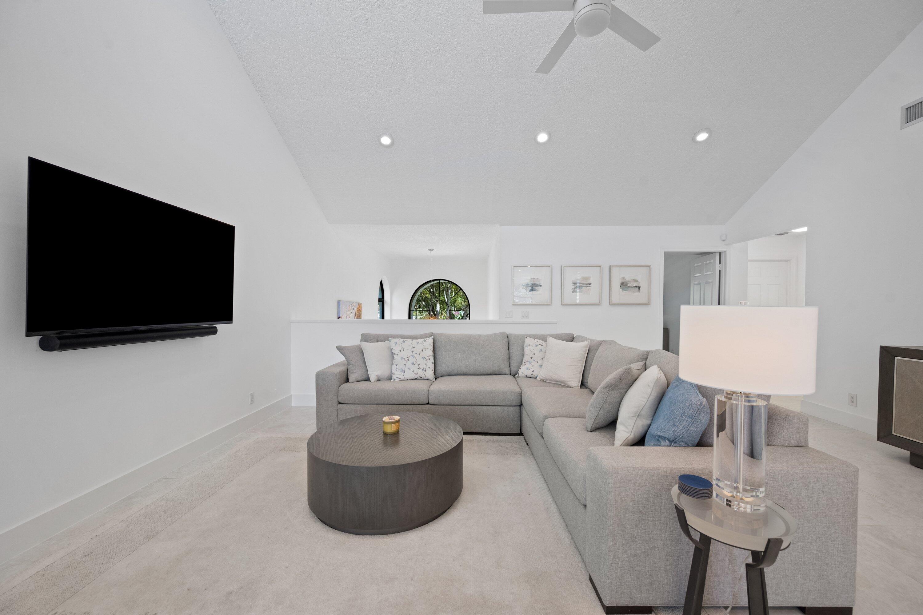 3940 Back Bay Drive, Unit 241 Jupiter, FL 33477 - Photo 5 of 19 a living room with furniture and a flat screen tv