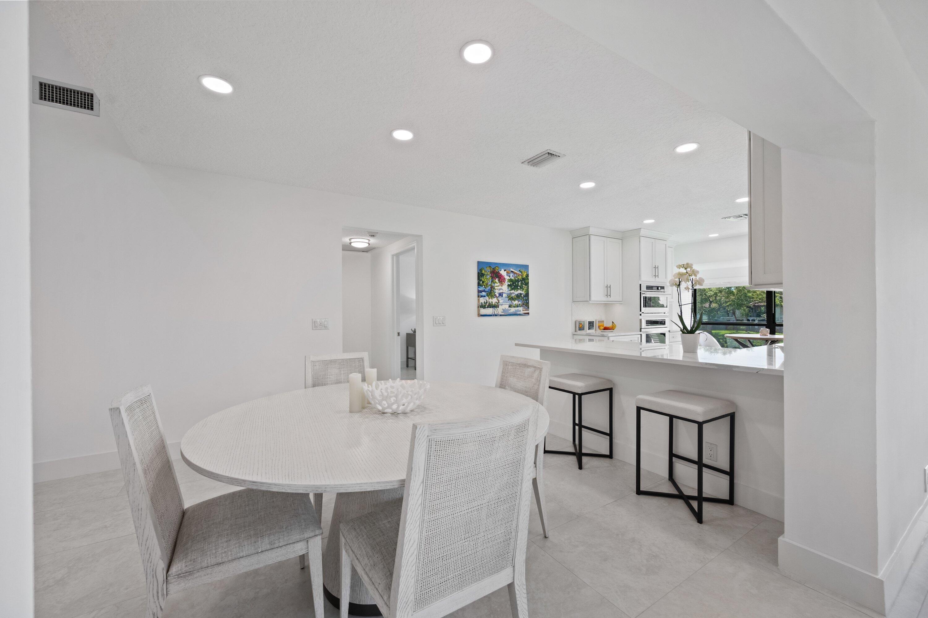 3940 Back Bay Drive, Unit 241 Jupiter, FL 33477 - Photo 6 of 19 a view of a dining room with furniture