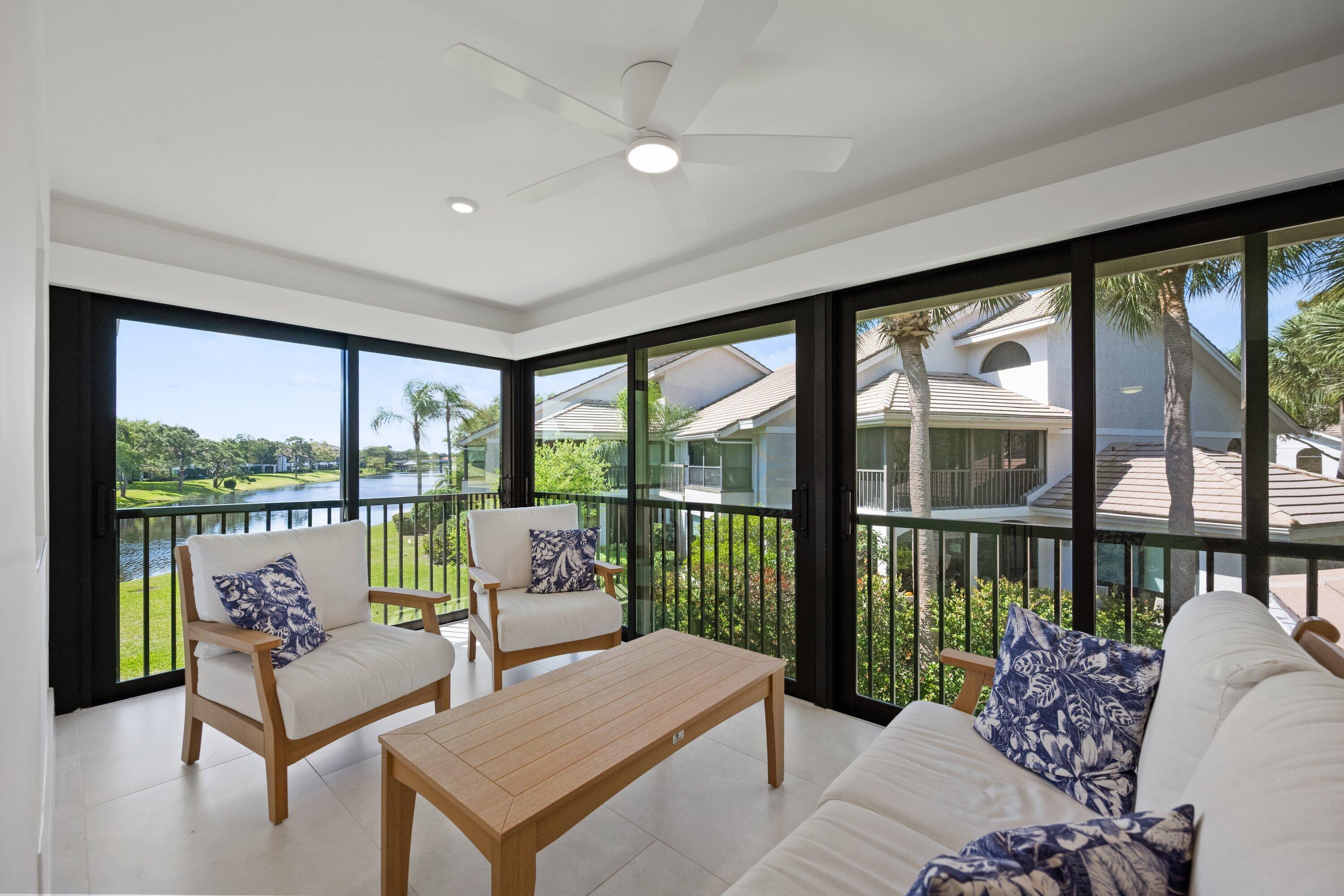 3940 Back Bay Drive, Unit 241 Jupiter, FL 33477 - Photo 10 of 19 a living room with furniture and a large window