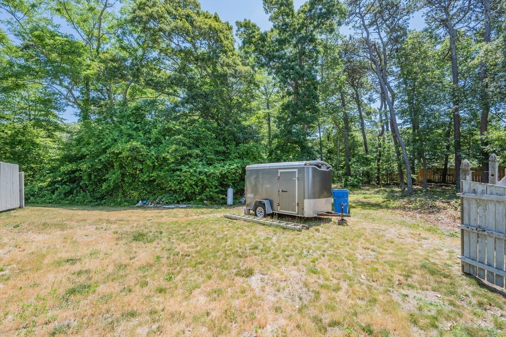 0 Underpass Road Brewster, MA 02631 - Photo 17 of 18 a backyard of a house with fountain and large trees