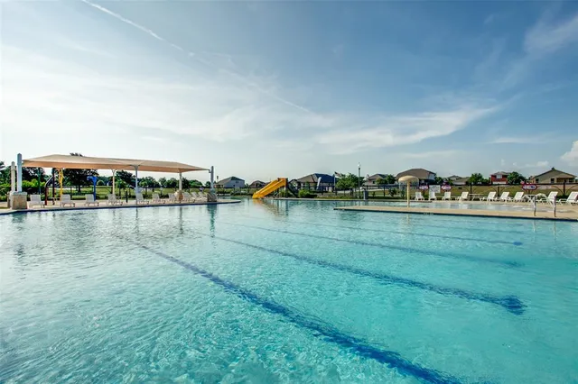a view of a swimming pool with lounge chair