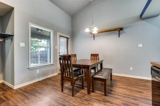 a kitchen with sink a refrigerator and chairs