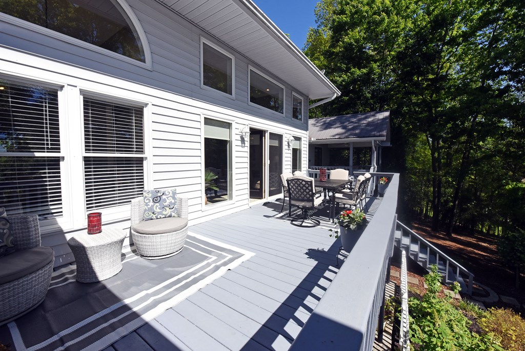 382 Pat Colwell Road Blairsville, GA 30512 - Photo 12 of 42 a view of a patio with chairs and floor to ceiling window