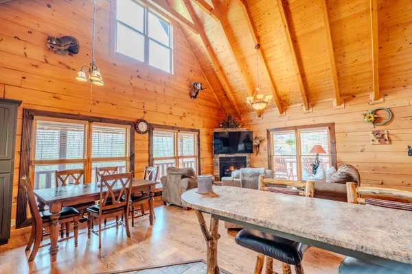 a view of a dining room with furniture and chandelier