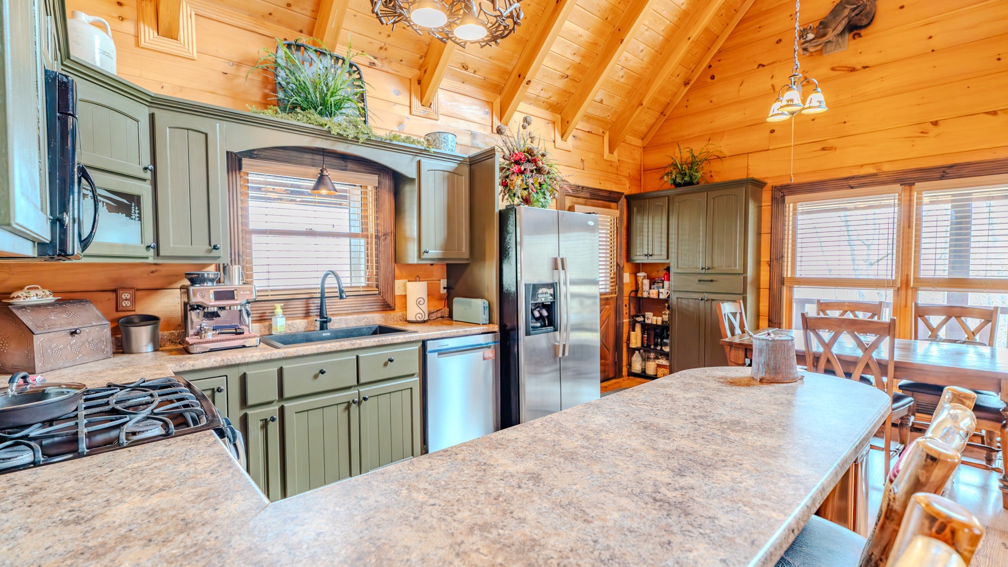 336 John J Smith Road Oneida, TN 37841 - Photo 20 of 61 a kitchen filled with stainless steel appliances kitchen island granite countertop a refrigerator a sink and wooden cabinets