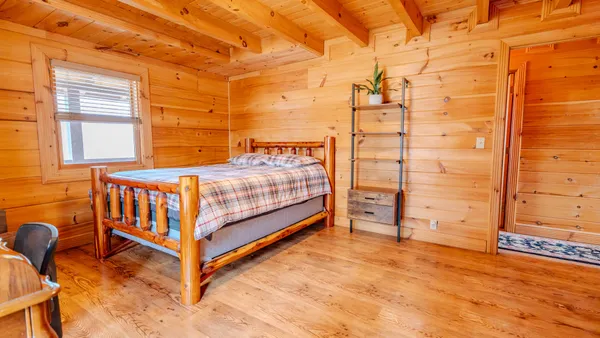 a bed sitting in a bedroom next to a window