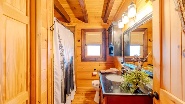 a bathroom with a shower curtain and a sink