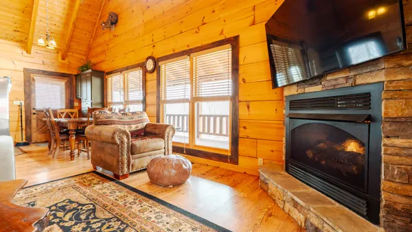 a view of a living room with a wooden floor and a large window