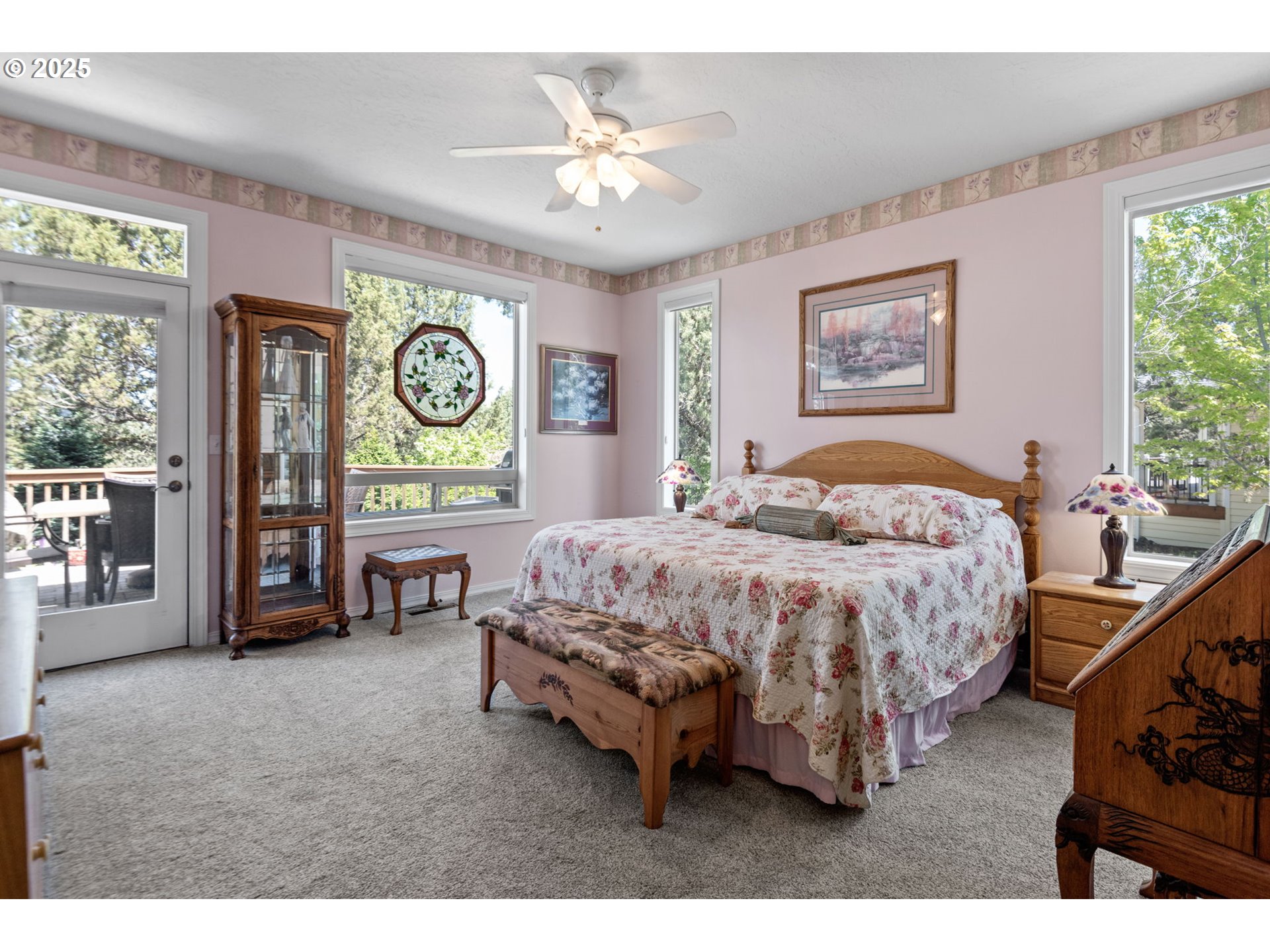 454 Tanager Drive Redmond, OR 97756 - Photo 14 of 31 a spacious bedroom with a bed and a chandelier
