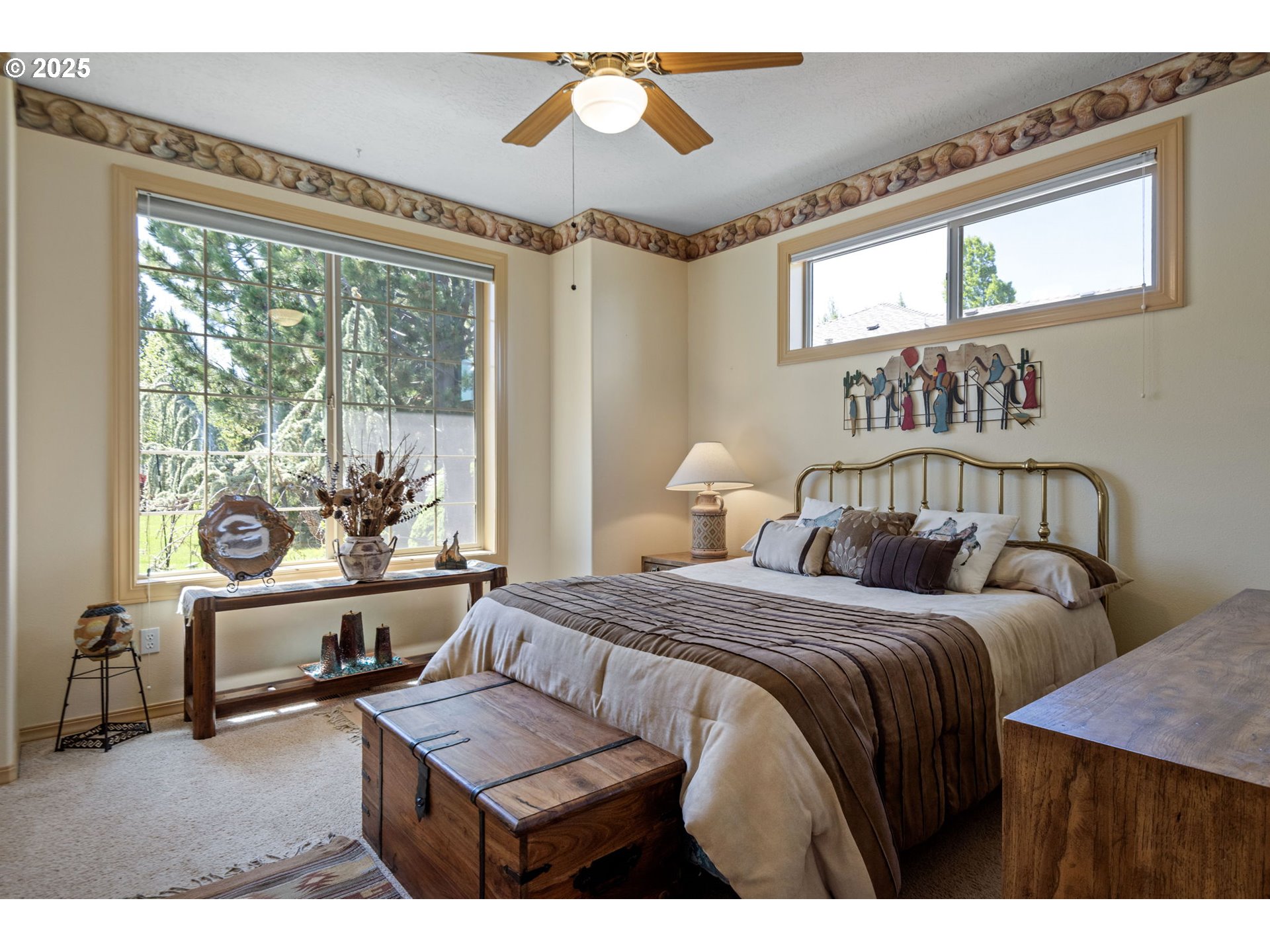 454 Tanager Drive Redmond, OR 97756 - Photo 19 of 31 a bedroom with a bed a couches and large windows