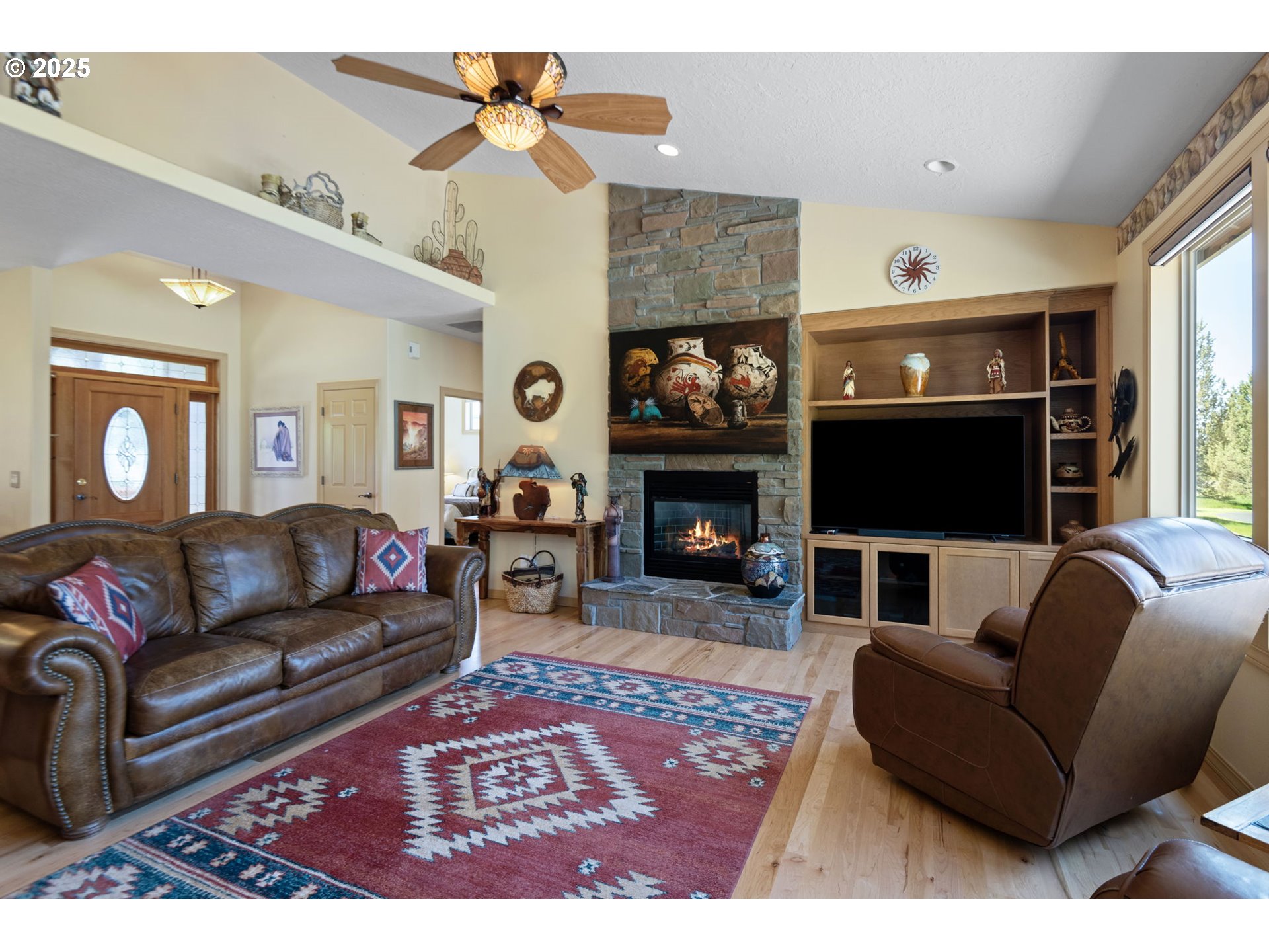 454 Tanager Drive Redmond, OR 97756 - Photo 6 of 31 a living room with furniture a flat screen tv and a fireplace