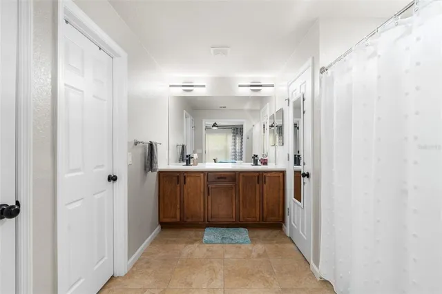 a bathroom with a mirror a double vanity sink and mirror