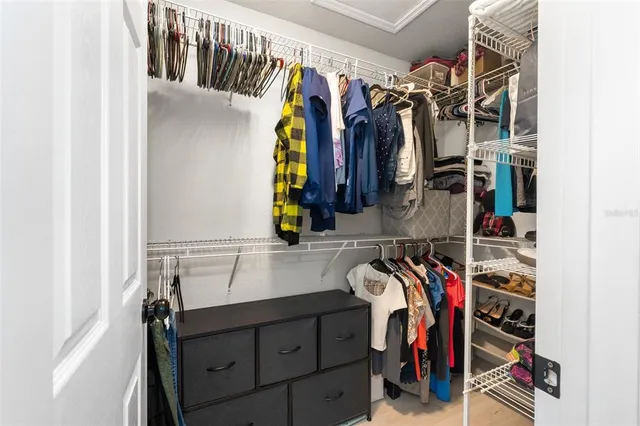 a view of walk in closet with clothes