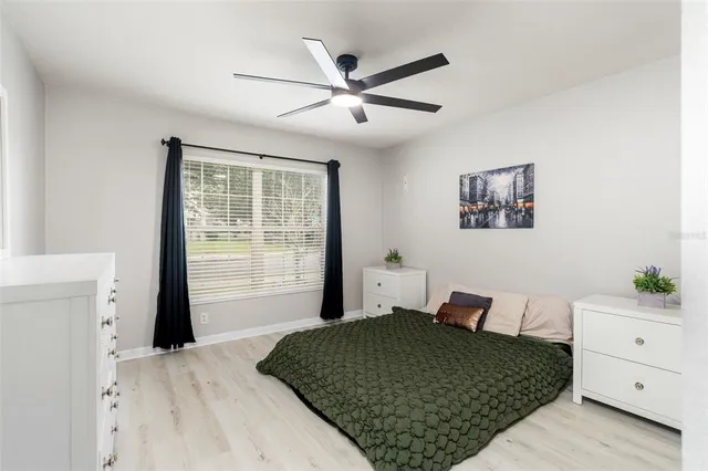 a bedroom with a large bed and a window