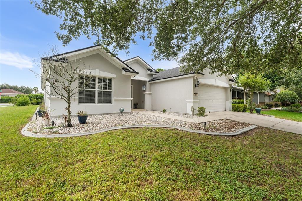 4098 Southwest 47th Court Ocala, FL 34474 - Photo 2 of 44 a view of a house with backyard and trees