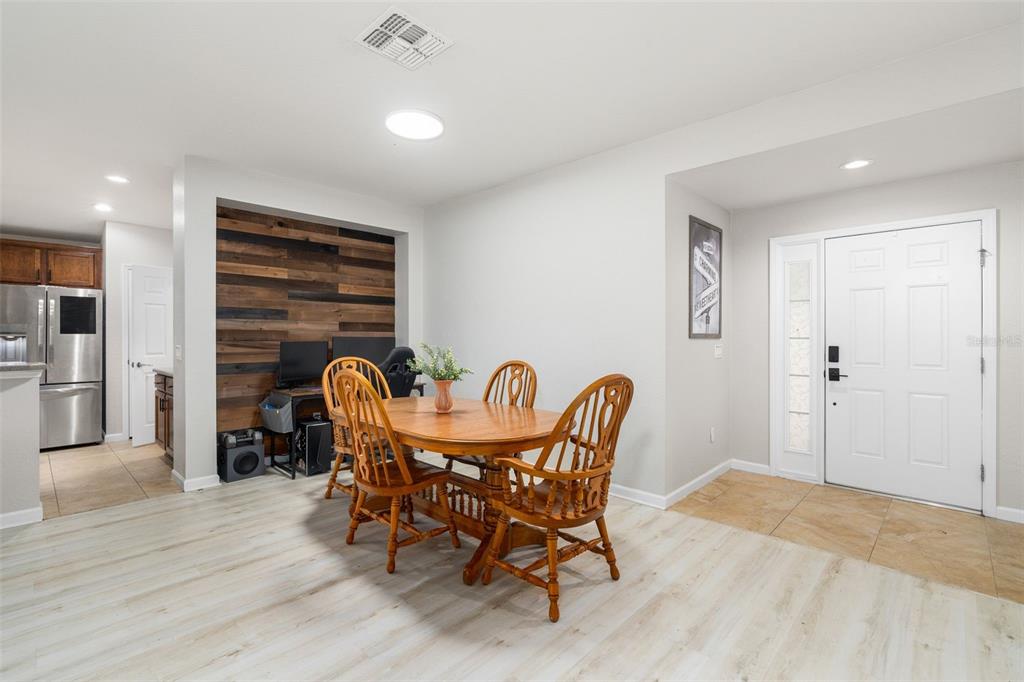 4098 Southwest 47th Court Ocala, FL 34474 - Photo 26 of 44 a view of a dining room with furniture and wooden floor