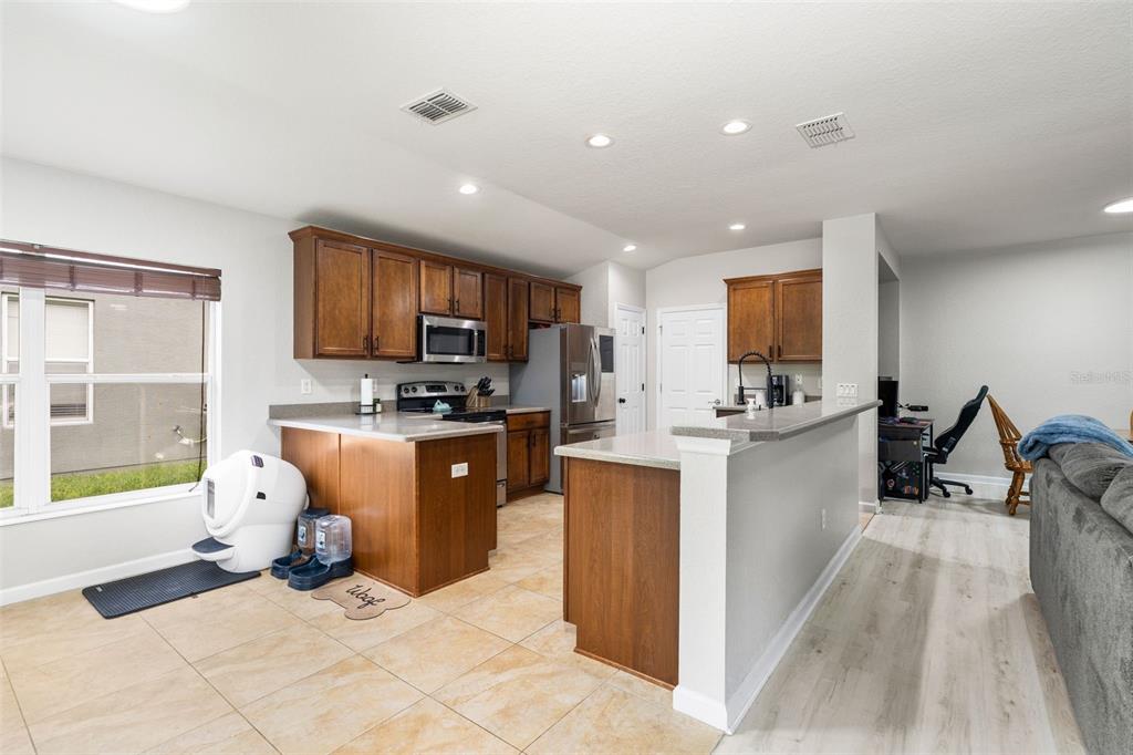 4098 Southwest 47th Court Ocala, FL 34474 - Photo 27 of 44 a open kitchen with sink refrigerator and cabinets