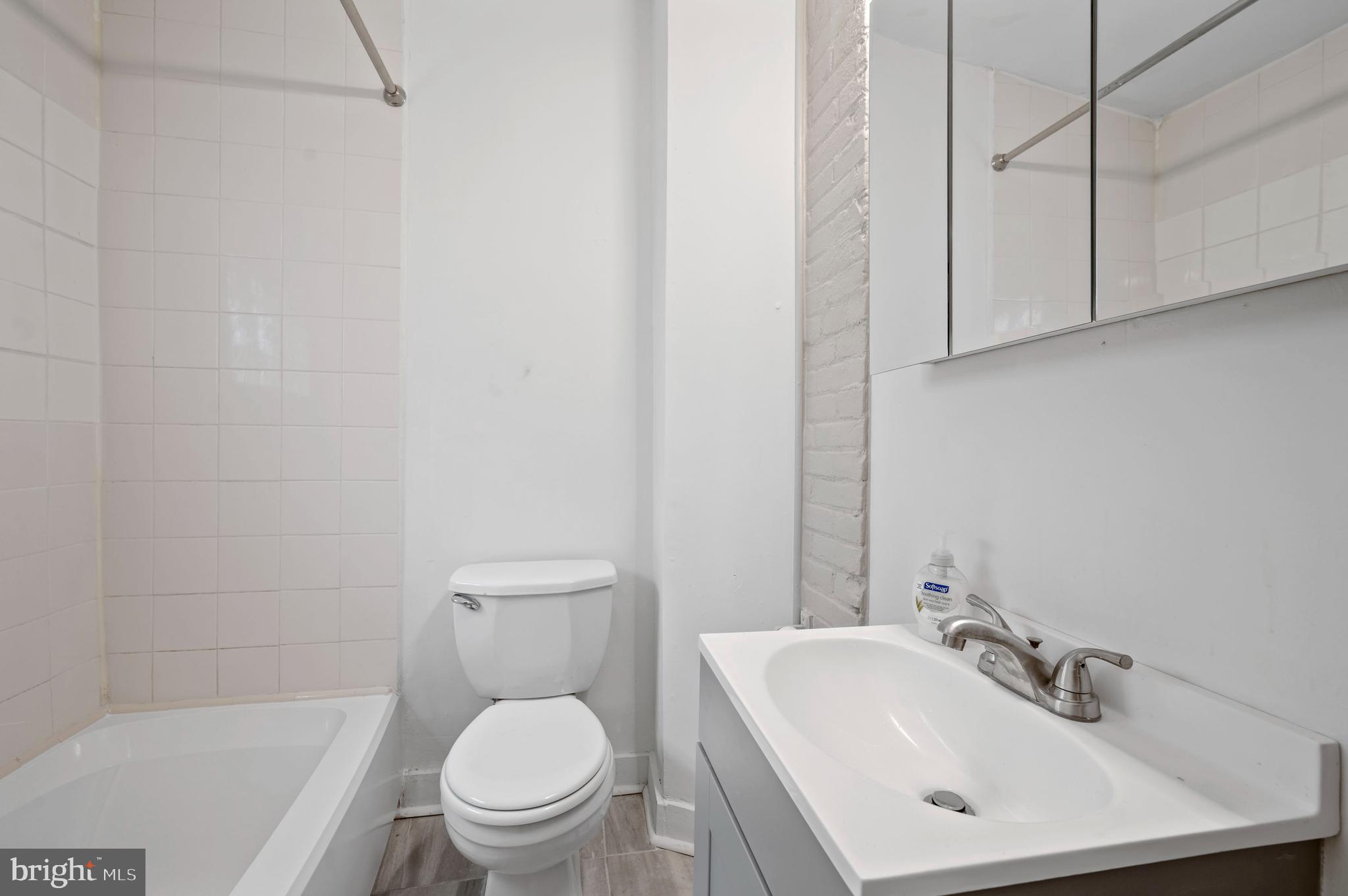 2304 Catharine Street, Unit 1 Philadelphia, PA 19146 - Photo 11 of 14 a bathroom with a sink a toilet and a mirror