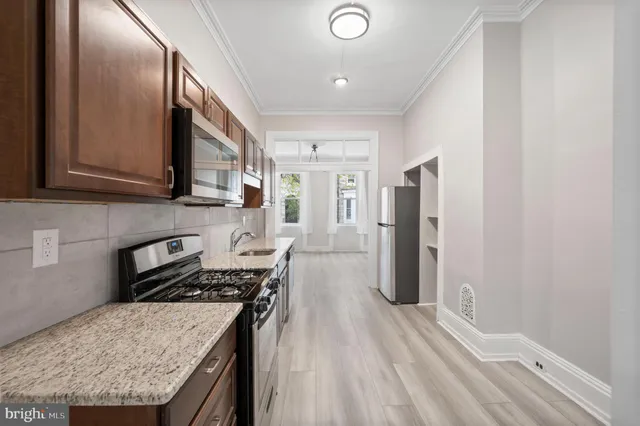 a kitchen with a refrigerator and countertop