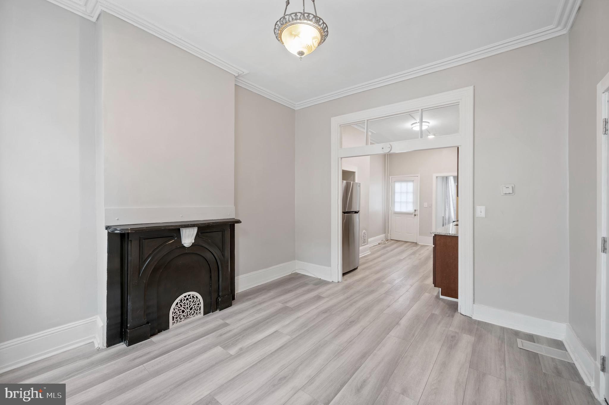 2304 Catharine Street, Unit 1 Philadelphia, PA 19146 - Photo 2 of 14 a view of a livingroom with wooden floor and a fireplace