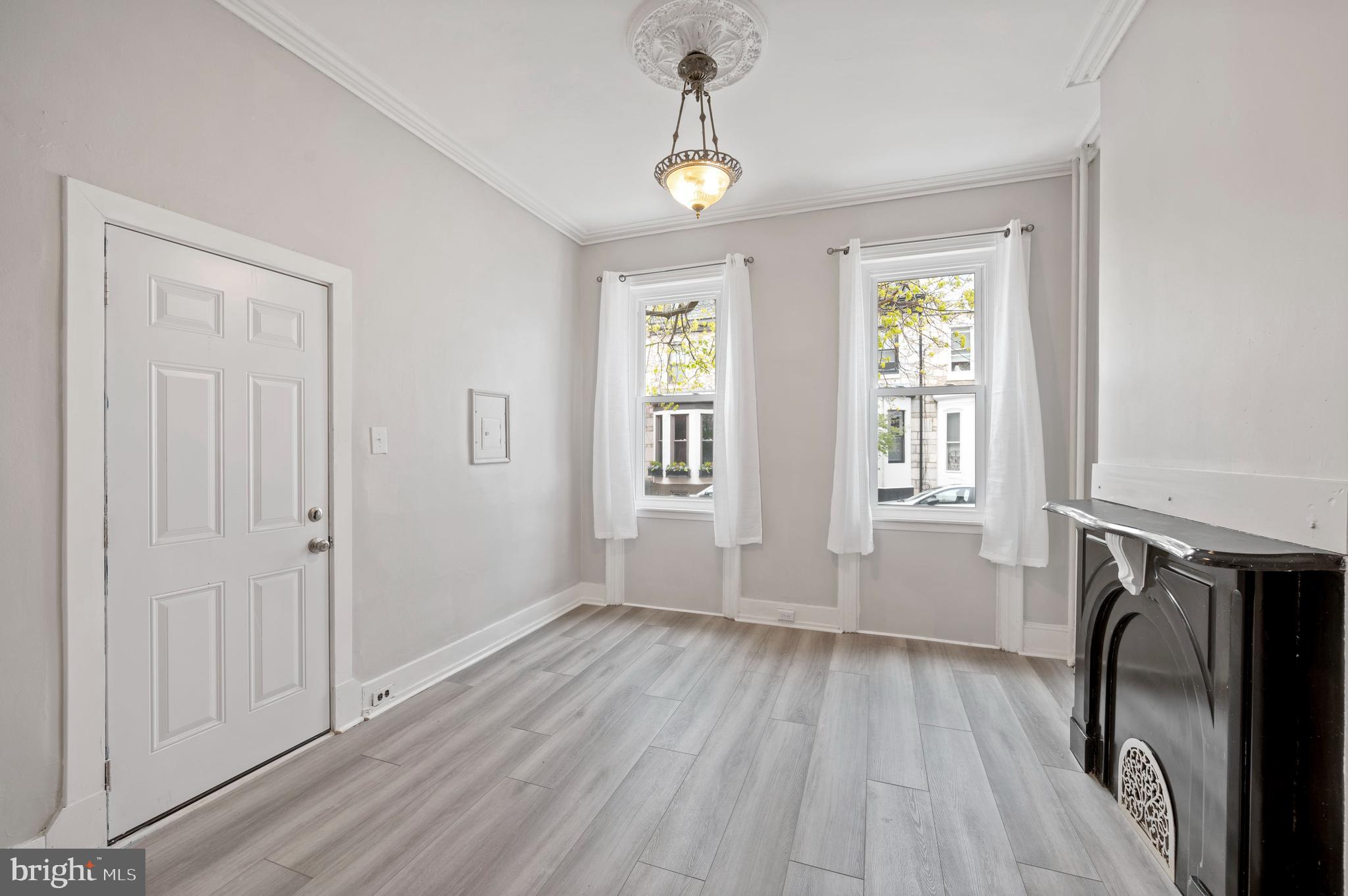 2304 Catharine Street, Unit 1 Philadelphia, PA 19146 - Photo 4 of 14 a view of empty room with wooden floor and fan