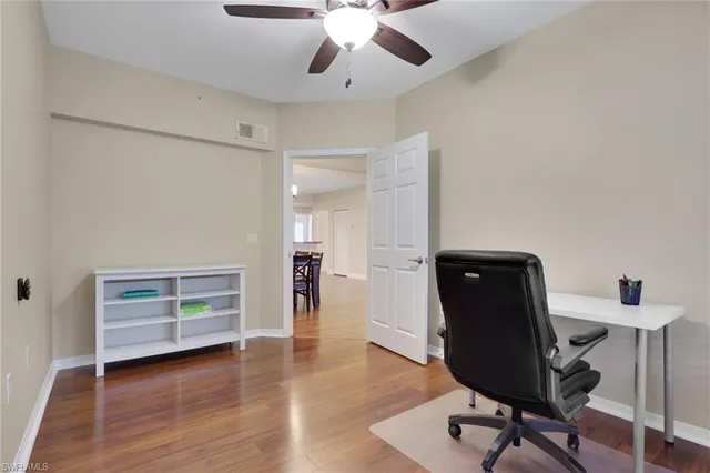 a view of room with furniture and wooden floor