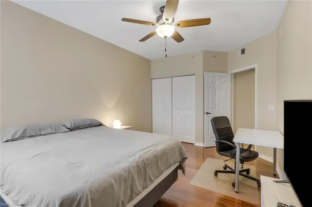 a bedroom with a bed and a desk