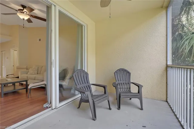 a view of a room with lounge chair wooden floor and windows