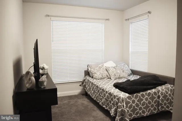 a bed sitting in a bedroom next to a window