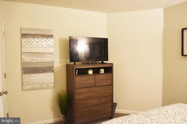 a bedroom with a bed and a television